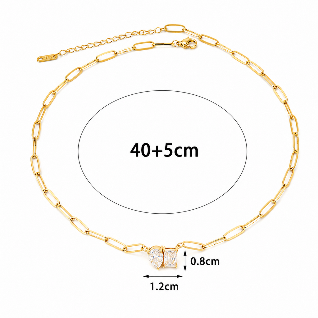 A gold-plated stainless steel chain for women featuring an elongated paperclip link design with a central pendant made of a pear-shape and emerald-shape stone joined together.