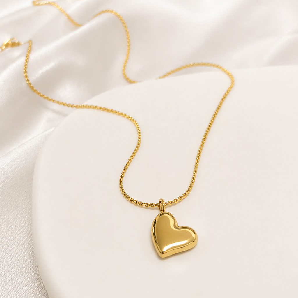 A gold-plated stainless steel chain for women featuring a polished 3D puffed heart pendant set at a tilt on a delicate link chain.