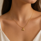 A gold-plated stainless steel chain for women being worn, featuring a polished 3D puffed heart pendant set at a tilt on a delicate link chain.