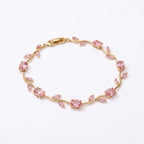 A gold-plated tulip vine chain bracelet for women featuring soft pink oval and marquise-cut stones, shown on a clean white background