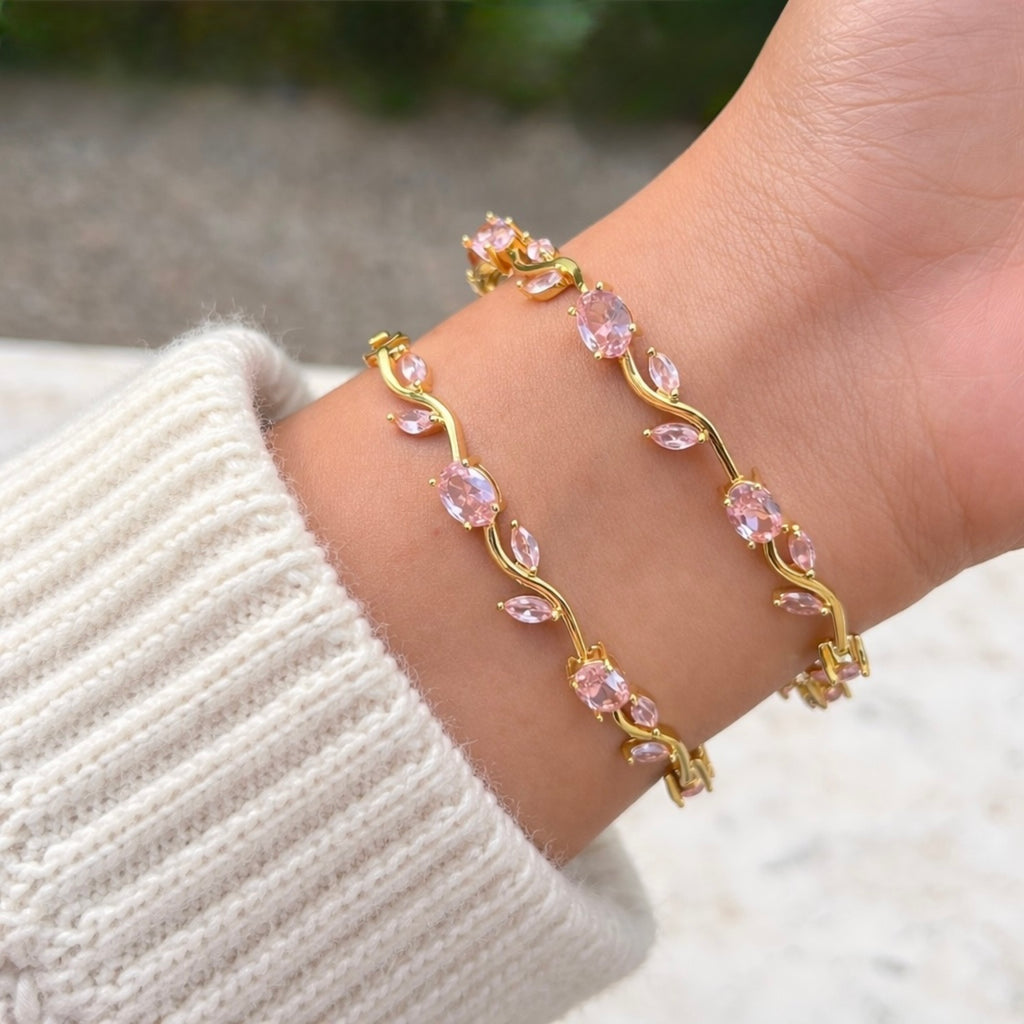 A gold-plated tulip vine chain bracelet for women featuring soft pink oval and marquise-cut stones, shown on a model