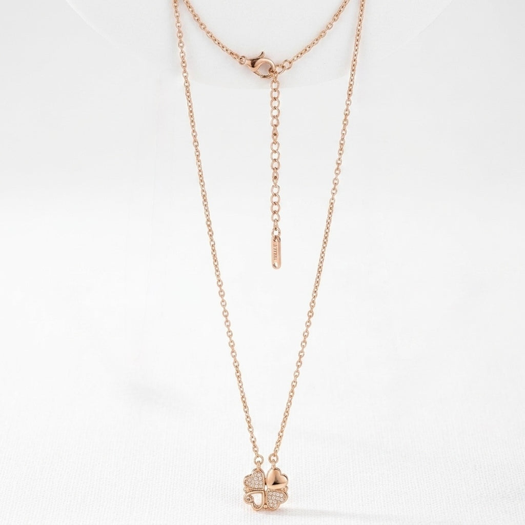 Rose gold necklace with a clover pendant on a white background