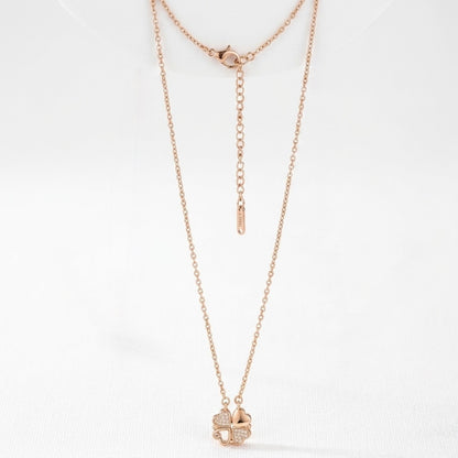 Rose gold necklace with a clover pendant on a white background