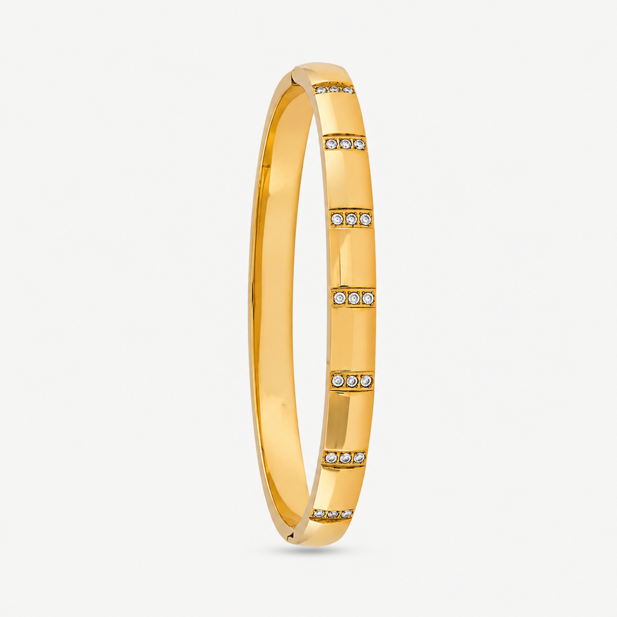 A close-view of a Crystal Bangle Bracelet with rectangular clear crystal accents on a gold-plated band.