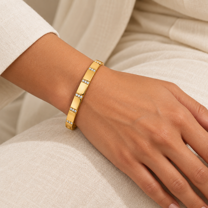 Crystal Bangle Bracelet with rectangular clear crystal accents on a gold-plated band, on a model