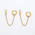 A pair of gold-plated ear chain earrings for women connecting a shimmering crystal bar stud to a small gold hoop with a fine chain