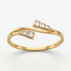 A gold-plated crossover bypass bangle for women featuring graduated baguette-cut crystals and a secure side-clasp.
