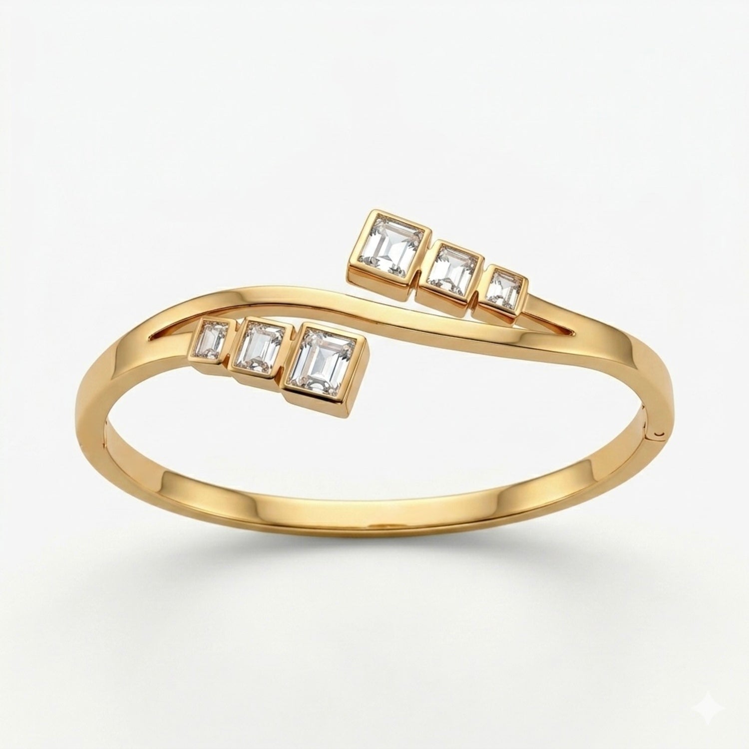 A gold-plated crossover bypass bangle for women featuring graduated baguette-cut crystals and a secure side-clasp.