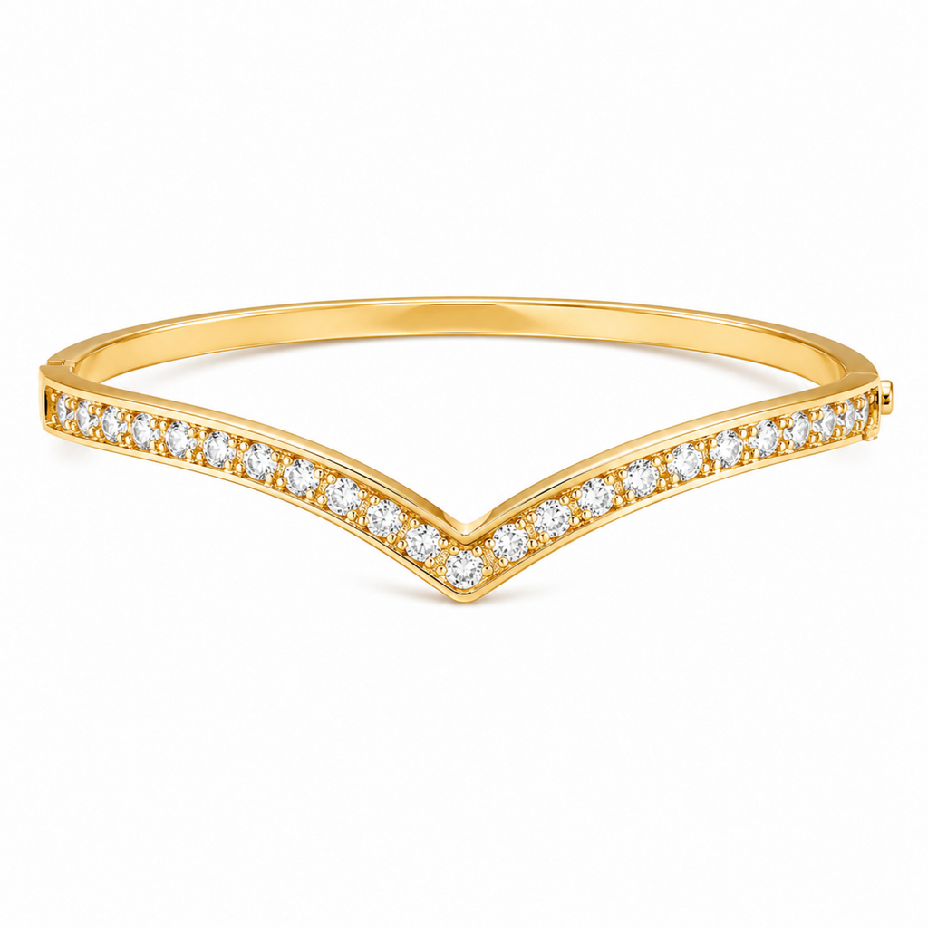 A gold-plated bangle for women featuring an intricate winged design and a secure side clasp