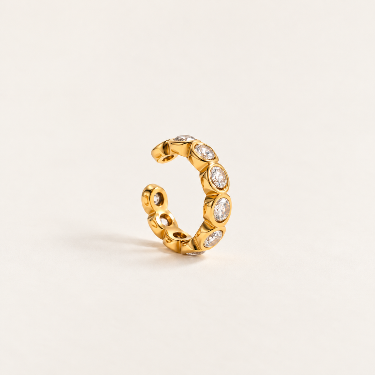 Gold-tone Crystal Ear Cuff with multiple clear faceted crystals in rounded settings.