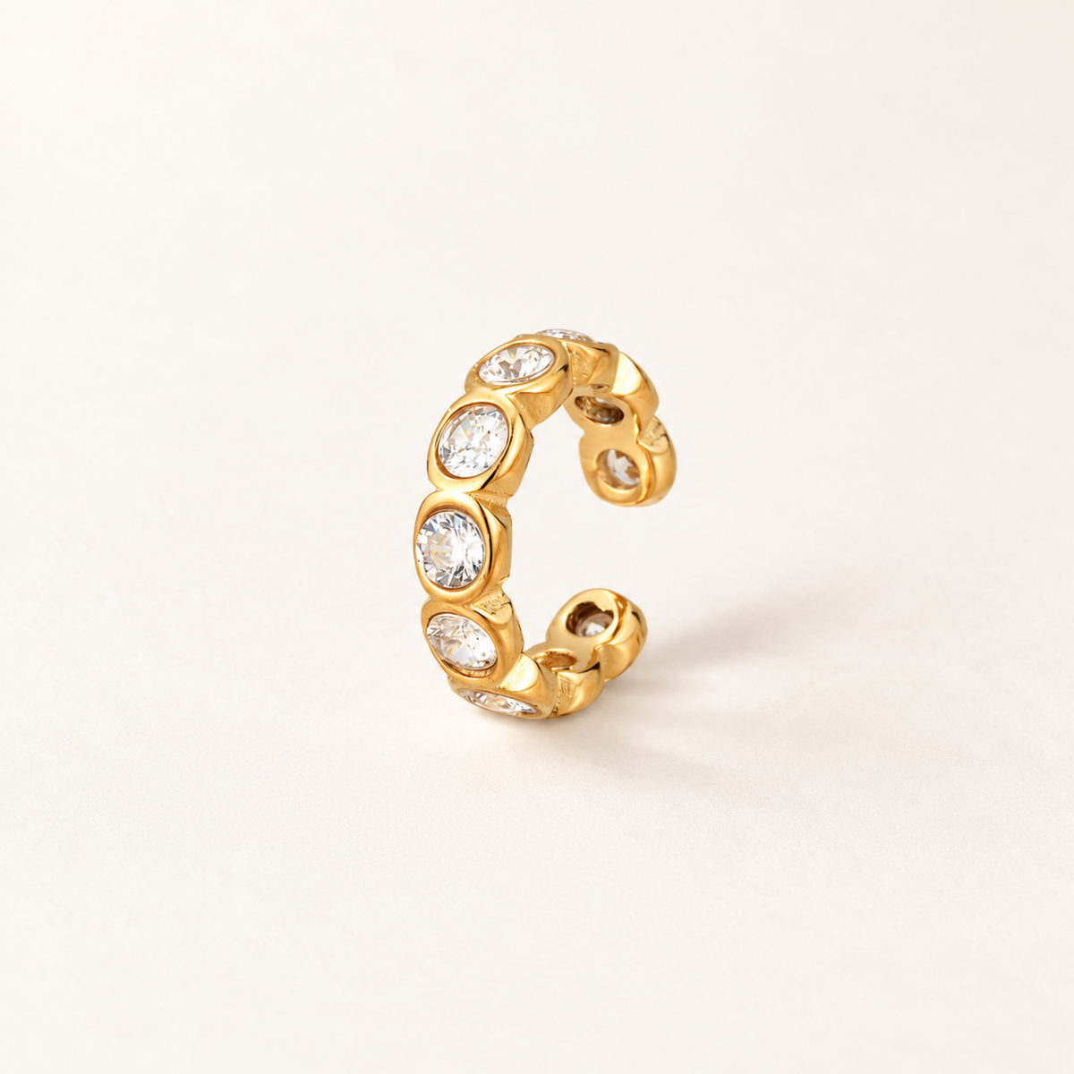 Gold-tone Crystal Ear Cuff with multiple clear faceted crystals in rounded settings.