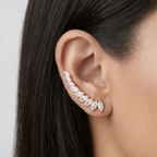 A  gold-plated celestial Zenith Starburst ear climber earrings for women featuring stones and a star motif on a model