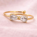 A close view of dainty gold plated adjustable ring for women featuring a bow design