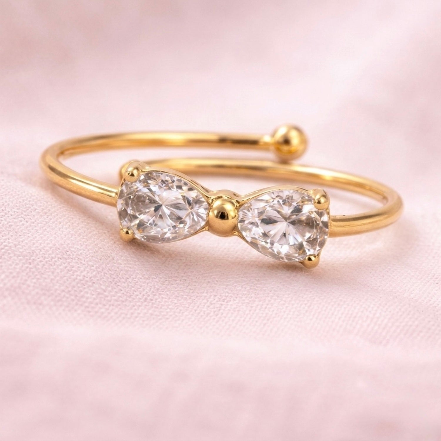 A close view of dainty gold plated adjustable ring for women featuring a bow design